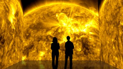 People standing in front of solar footage