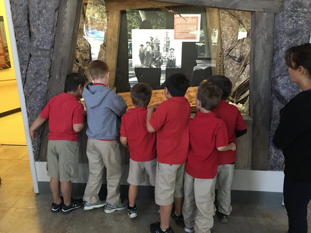 Children peeking into a display at the museum.