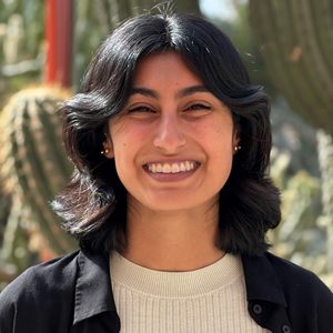 Headshot of Kyra Bonilla in front of cactus garden.