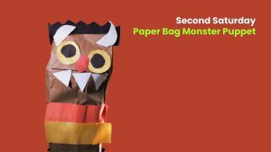 Paper bag monster puppet with large eyes, horns, and paper teeth beside text promoting a “Second Saturday” craft activity.