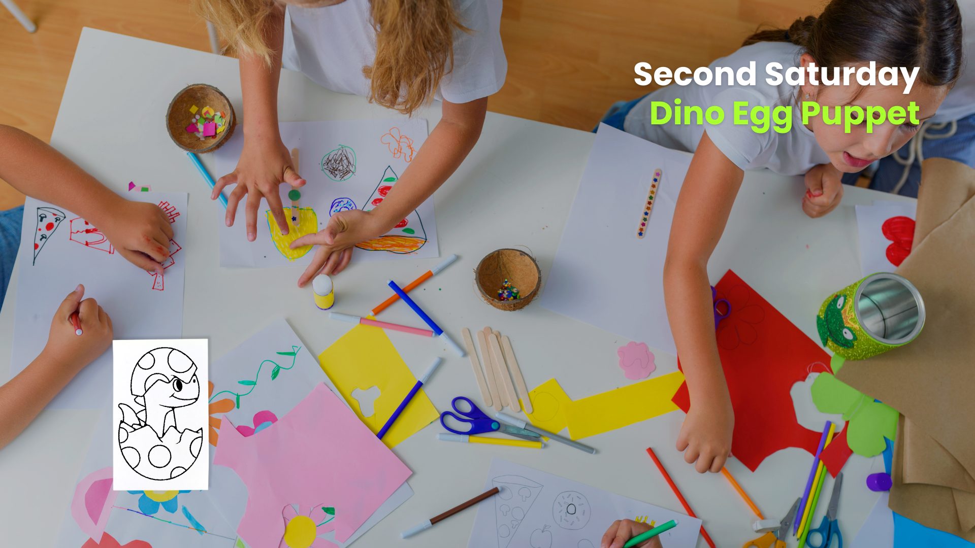 Children drawing and crafting at a table filled with paper, markers, and supplies during a “Second Saturday” puppet activity.